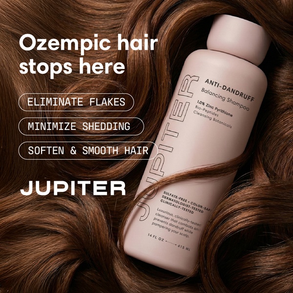 A high-contrast, benefit-led product ad featuring a shampoo bottle centered among luxurious, healthy-looking hair.