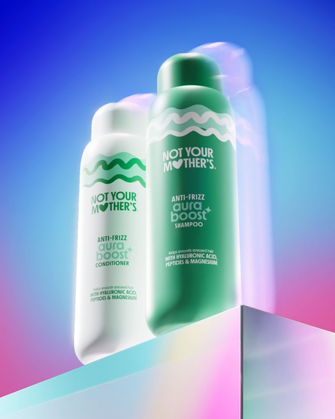 A high-quality 4:5 ratio hero product shot featuring shampoo and conditioner bottles on a reflective, colorful gradient platform.