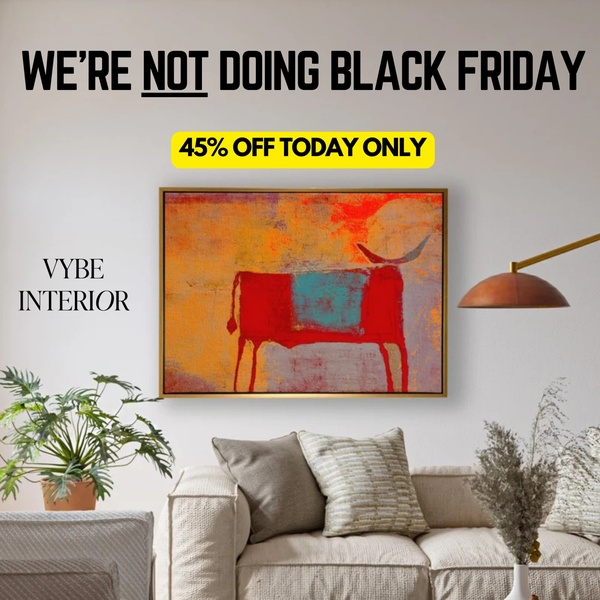 A minimalist living room setting featuring a piece of framed wall art, utilizing a bold text-based hook that challenges standard Black Friday sales trends.