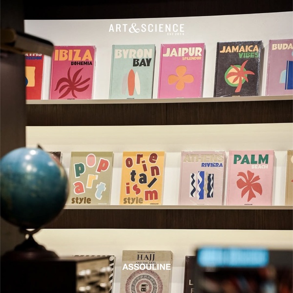 This creative showcases a curated shelf of travel and art-themed coffee table books, using organized, vibrant spines to create an aspirational shopping experience.