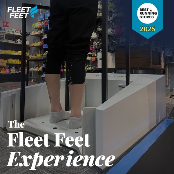 A close-up, perspective-focused shot showing a customer standing on a professional gait analysis platform inside a retail store.