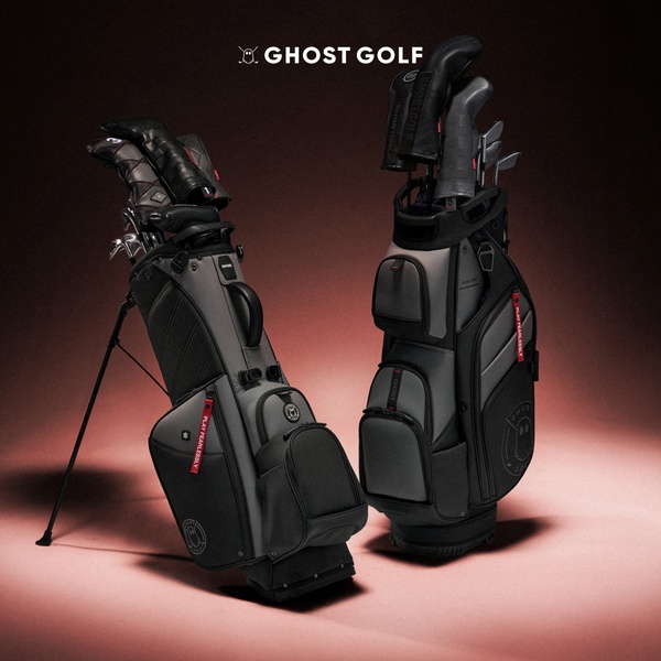 A high-contrast, professional product hero shot featuring two premium golf bags set against a dark, moody background with subtle warm lighting.