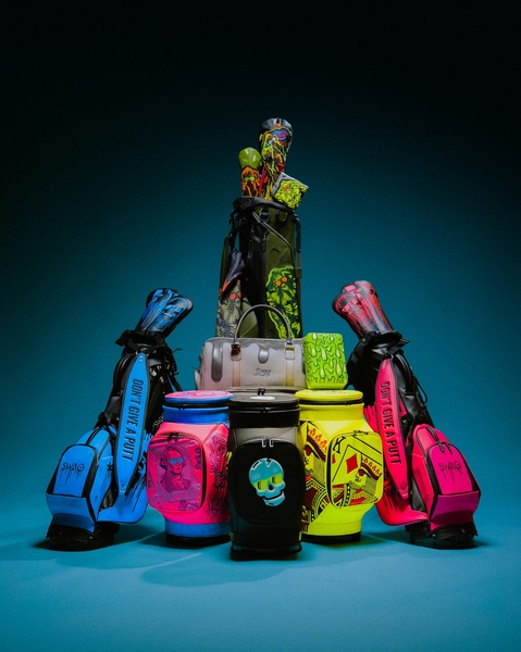 A high-impact, studio-lit photograph featuring a diverse array of colorful, patterned golf bags arranged in a symmetrical pyramid to highlight brand aesthetic.