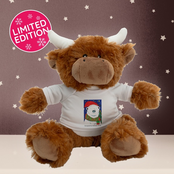 A brown highland-style stuffed animal wearing a white t-shirt with a seasonal polar bear design, presented with a limited edition badge.