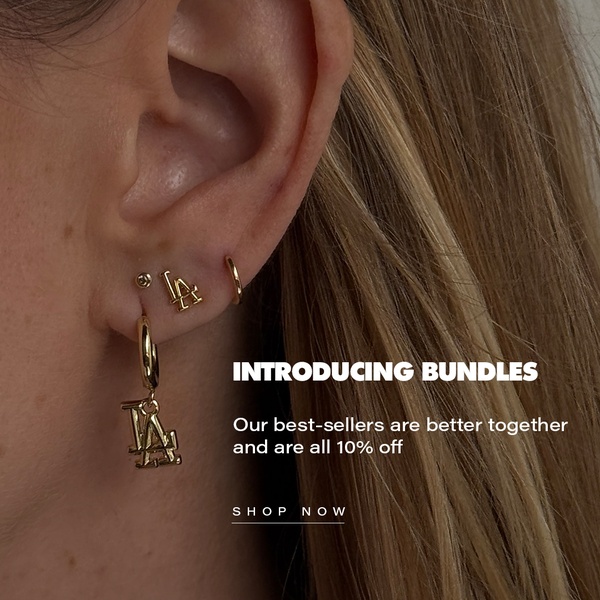 A close-up photograph of an ear wearing multiple gold earring pieces, highlighting a promotional offer for product bundles.