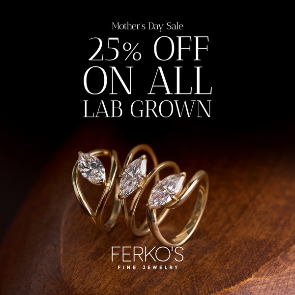 A high-end, clean product advertisement showcasing three marquise-cut diamond rings resting on a warm, dark wooden background.