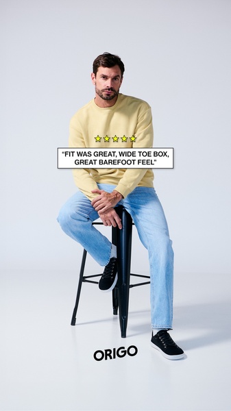 A clean, studio-lit ad creative featuring a model wearing barefoot sneakers with a prominent five-star customer review overlay.