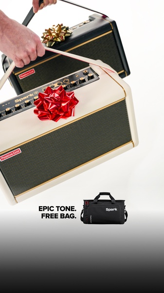 A high-contrast visual showing a guitar amplifier decorated with a gift bow, paired with a free equipment bag to highlight a promotional offer.