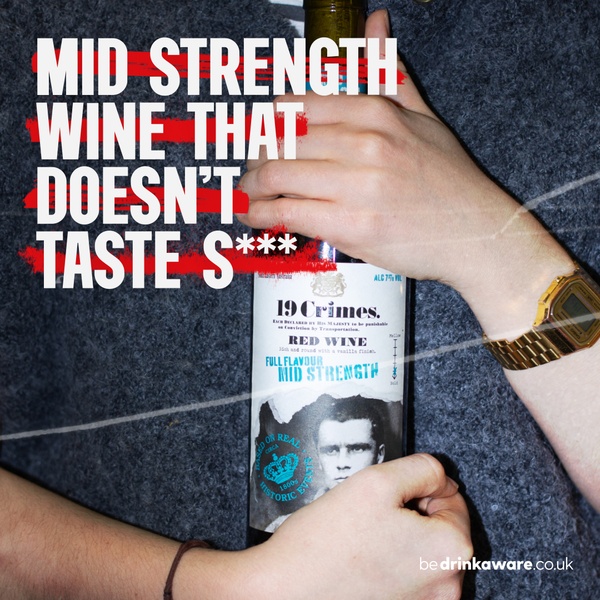 A close-up shot of hands holding a bottle of mid-strength red wine, featuring a provocative headline about taste.