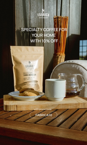 A high-quality lifestyle shot featuring a bag of specialty coffee, a cup of fresh brew, and biscuits on a wooden table, emphasizing a cozy, premium home experience.