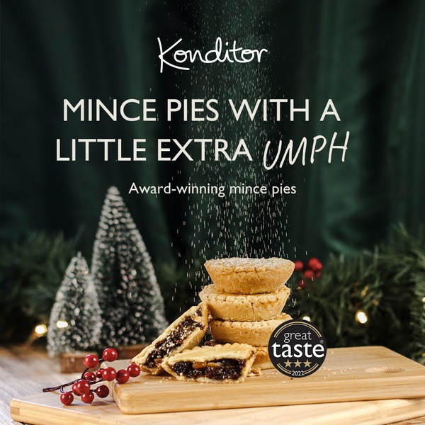 A high-quality product hero shot featuring mince pies dusted with powdered sugar, utilizing a festive, dark, and moody color palette.