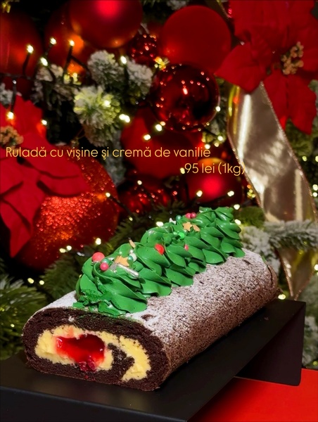 A high-quality product photo of a festive cake roll placed against a decorated Christmas tree background to highlight seasonal offerings.