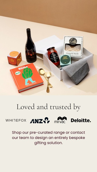A high-end flat-lay presentation of a gift box containing gourmet food items, wine, and lifestyle goods, designed to showcase a curated, premium experience.