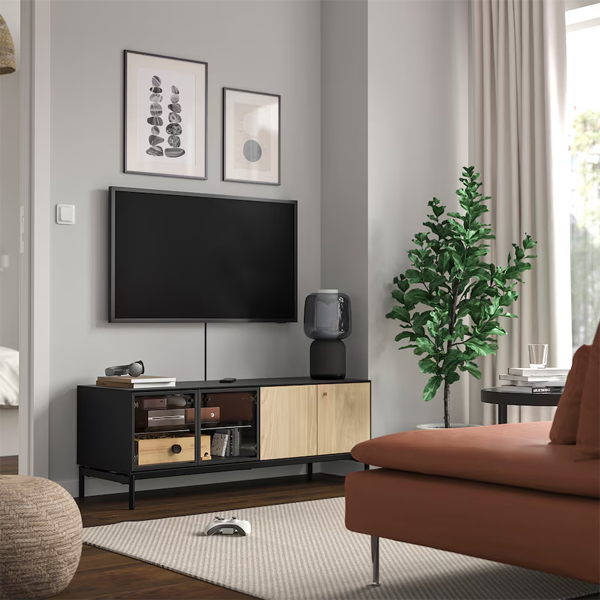 A high-quality lifestyle shot featuring a modern media console integrated into a neutral, calming interior design setting to drive product desirability.