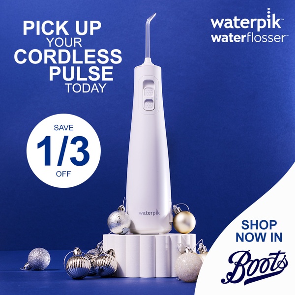 A festive, high-contrast ad for a cordless water flosser, featuring a direct 1/3 off discount call-to-action against a deep blue background.