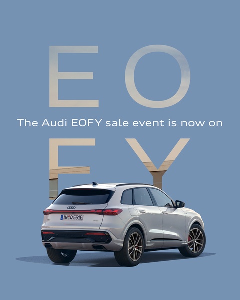 A seasonal sale ad for a luxury SUV featuring a clean, minimalist layout with bold, overlapping typography that frames the vehicle.
