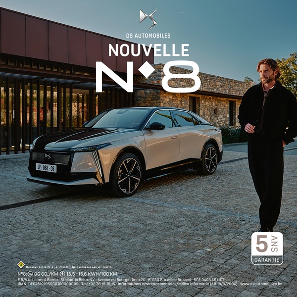 A sophisticated, high-end, square-ratio advertisement featuring a luxury sedan parked in front of a modern stone building with a stylish model standing beside it.