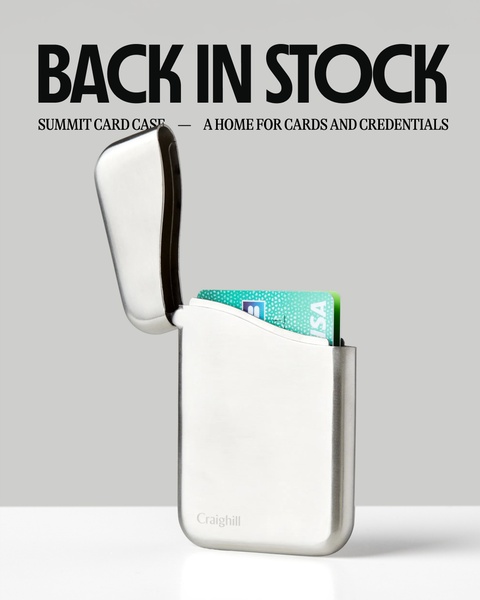 A clean, high-contrast creative highlighting the opening of a sleek metal card case against a neutral studio background.
