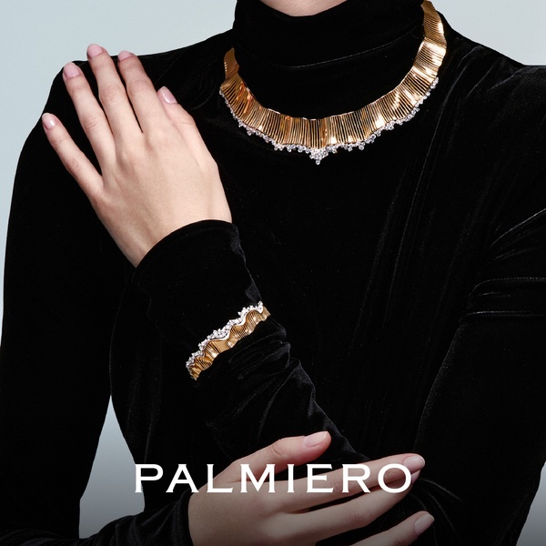 A close-up, high-end shot showcasing a gold necklace and bracelet set against a black velvet backdrop, emphasizing texture and luxury.