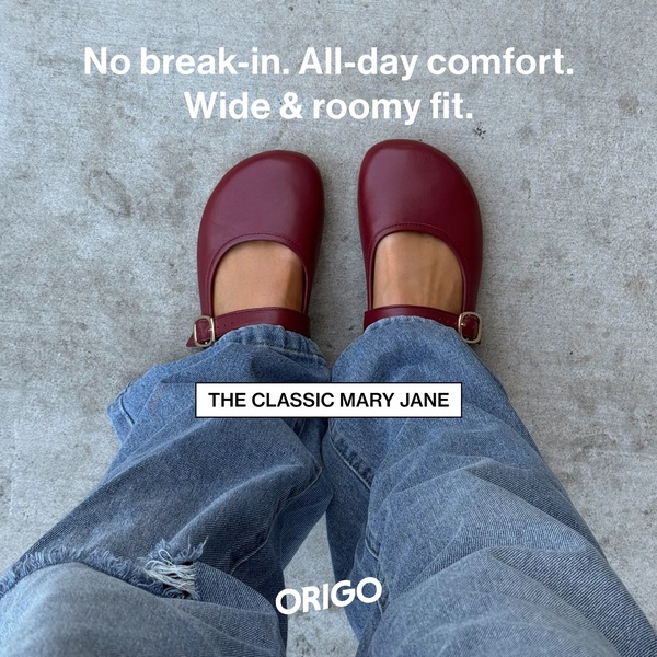 A first-person point-of-view shot of Mary Jane shoes on a neutral concrete surface, highlighting their fit and comfort.