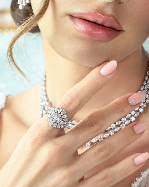 A close-up aesthetic shot of a diamond ring being worn, emphasizing texture, elegance, and premium product quality.