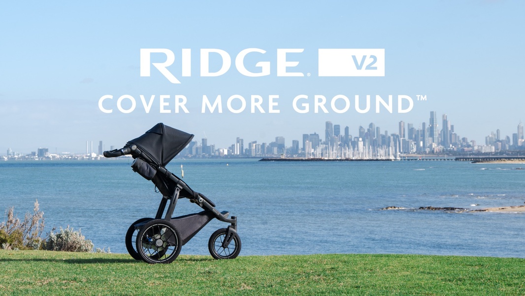 A minimalist, wide-shot product ad for the Ridge V2 stroller, using a scenic background to emphasize outdoor utility and adventure.