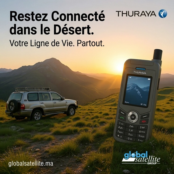 A static ad featuring a satellite phone placed in a desert landscape to communicate reliability and connectivity in remote environments.