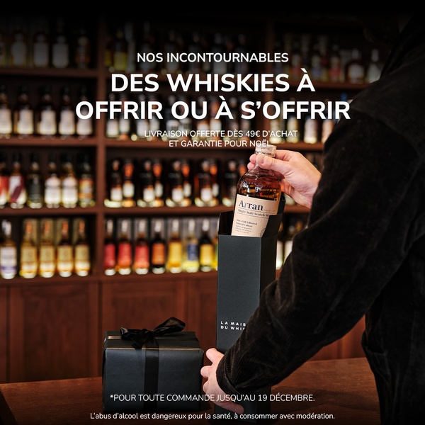 This creative showcases a premium bottle of whiskey being prepared for gift-giving in a sophisticated, retail-store setting.