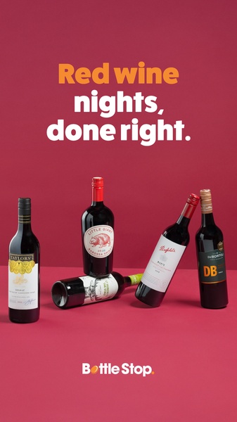 A clean, minimalist product hero shot featuring multiple wine bottles arranged on a solid red background with bold typography.