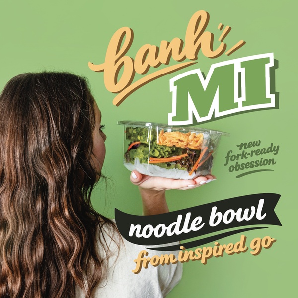 A 1:1 format ad featuring a side profile of a person holding a clear container of a Banh Mi inspired noodle bowl against a solid sage green background.