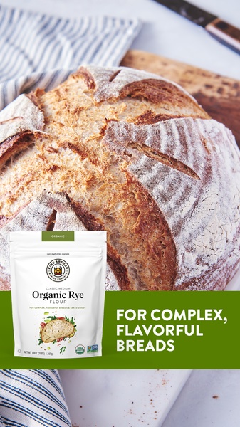 A top-down 9:16 vertical creative featuring a rustic, crusty loaf of bread alongside the product packaging and a bold value proposition.