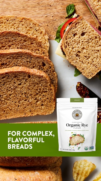 A 9:16 vertical creative featuring a gourmet sandwich next to an Organic Rye Flour bag, emphasizing artisan bread quality.