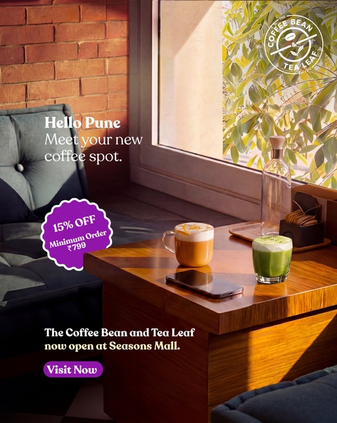 A warm, inviting scene showcasing two beverages on a table by a sunlit window to announce a new store location and offer.