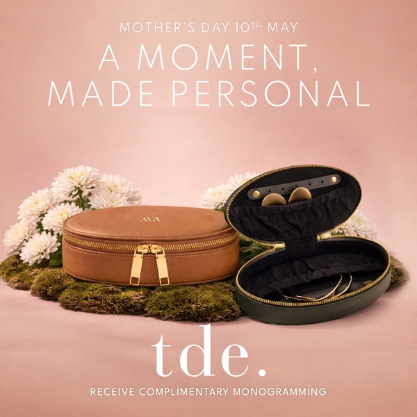 A refined product shot of two open jewelry cases styled with flowers and moss, emphasizing a personalized, premium gifting experience for Mother's Day.