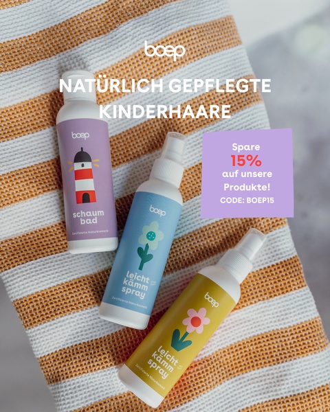 A clean, bright flat-lay photography style showcases three natural baby care products on a striped textile background with an overlay discount code.