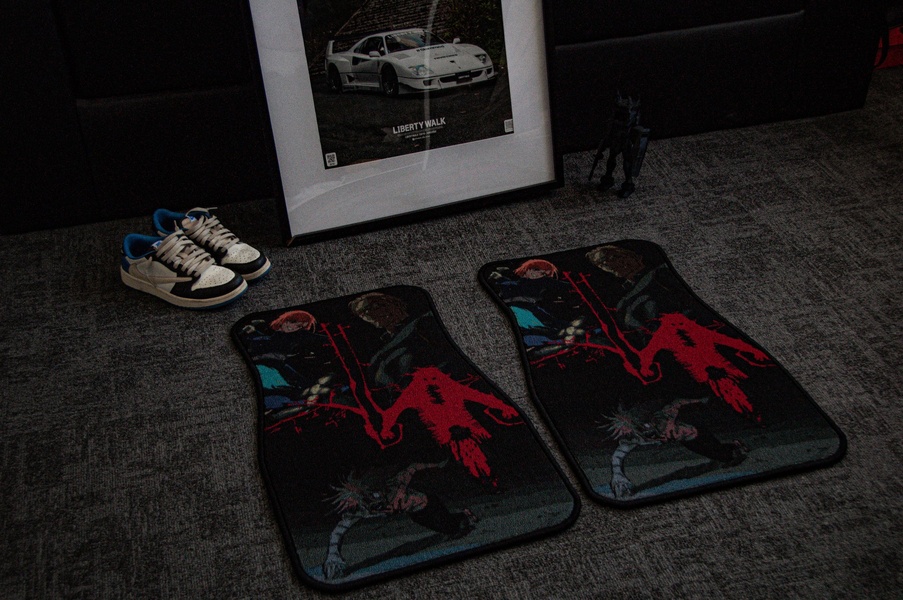 A high-contrast product shot featuring two character-themed car floor mats displayed alongside lifestyle items on a dark textured background.