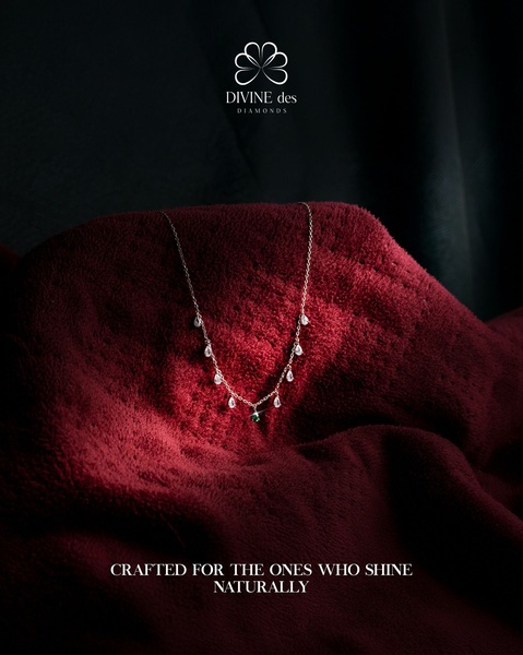 A delicate diamond necklace is artfully draped over rich, deep red velvet fabric, emphasizing a luxury aesthetic with soft, dramatic lighting.