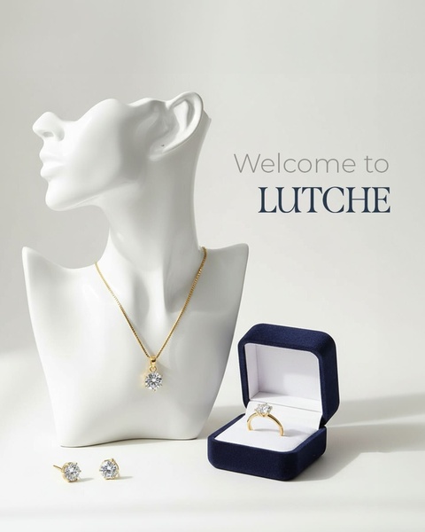 A high-end, clean product photography layout featuring a gold necklace, ring, and earrings on a white bust and inside a blue velvet box.