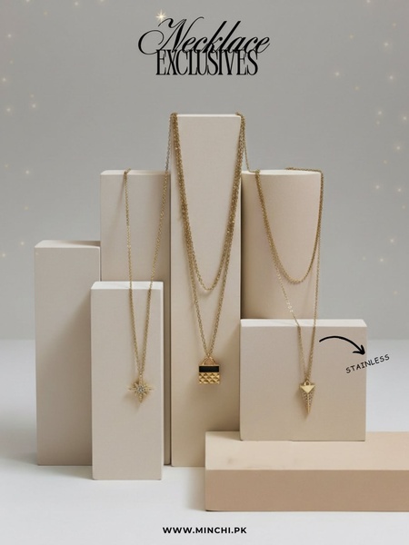 A high-end studio display featuring three distinct gold necklaces draped over minimalist geometric pedestals in a neutral beige palette.