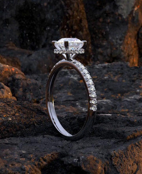 This creative highlights a diamond engagement ring placed on a dark, volcanic rock surface to create a high-contrast luxury aesthetic.