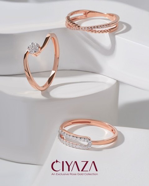 A high-end, clean studio shot featuring three distinct rose gold ring designs arranged on abstract white geometric platforms.