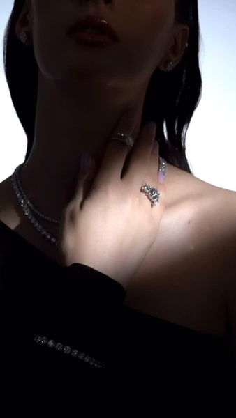 A high-end 9:16 portrait shot featuring diamond jewelry, using dramatic lighting and close-up focus to evoke a premium brand feeling.