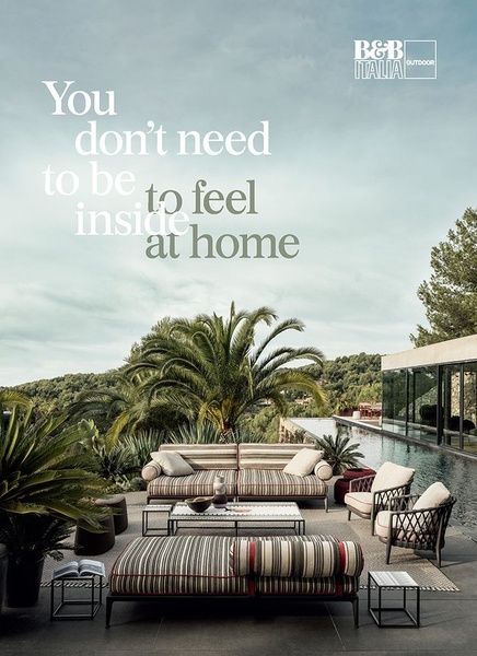 An outdoor sofa placed on a pristine poolside terrace, demonstrating a seamless blend of indoor-level comfort with high-end outdoor architecture.