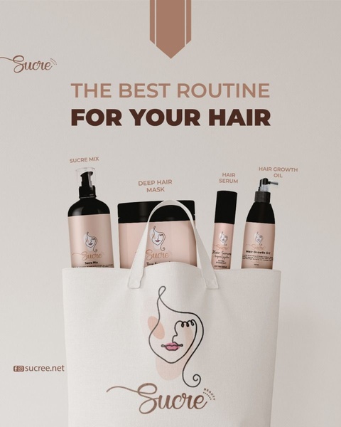 A clean, minimalist product display featuring a curated collection of four hair care bottles inside a branded tote bag.