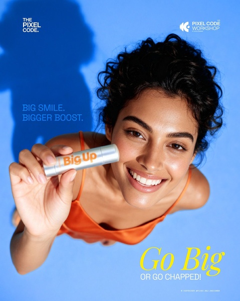 A close-up, high-angle lifestyle shot of a smiling person holding a lip balm, using vibrant blue and orange color blocking to create visual impact.
