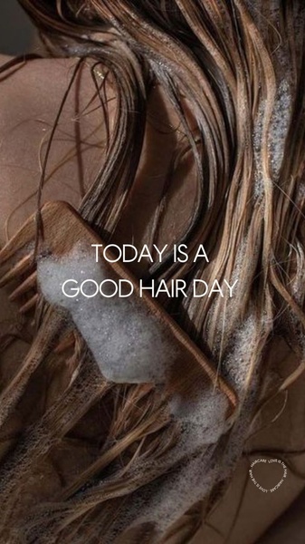 A close-up, high-quality shot of a hair treatment being applied with a wooden comb during a shower routine, featuring simple, bold text.