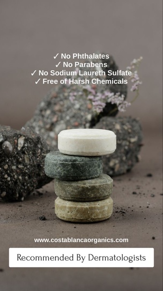 A clean, studio-lit photograph of stacked natural shampoo bars with a clear, benefit-driven bulleted list of excluded chemicals.