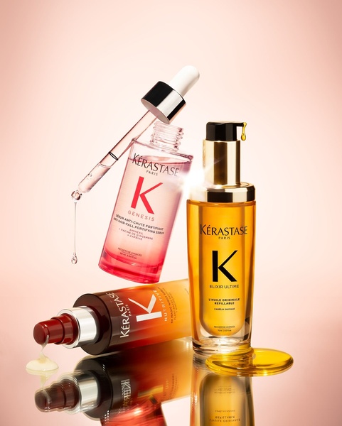 This creative showcases multiple serum bottles in a high-key, warm-toned studio setup, emphasizing product texture and clarity.