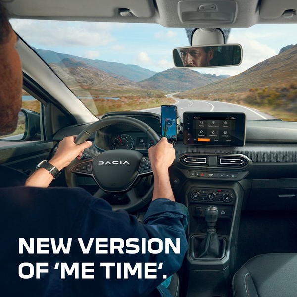 A driver perspective shot from the interior of a vehicle, highlighting the clean, modern dashboard and the scenic, open road ahead.