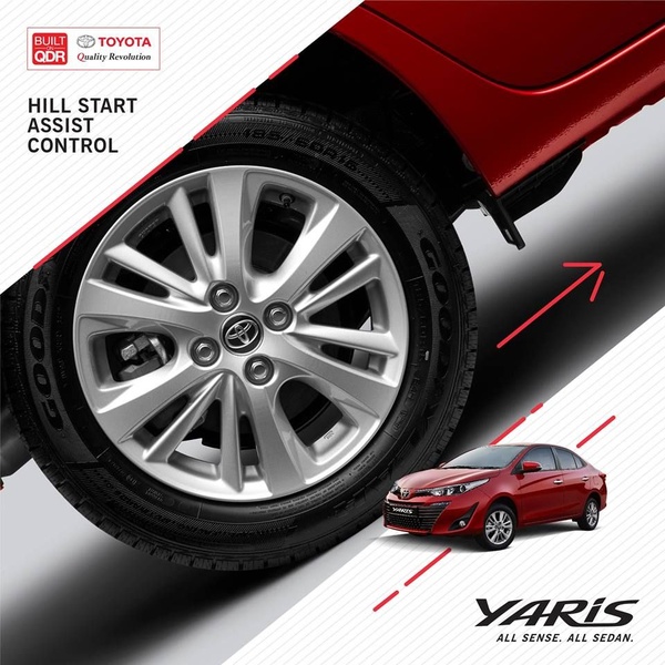 A close-up shot of a sedan wheel with red directional arrows and a smaller secondary view of the vehicle to highlight specific safety technology.
